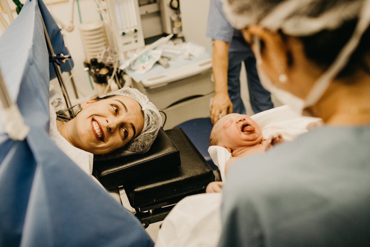who-we-are Mother Smiling Looking At Newborn Child 3279203